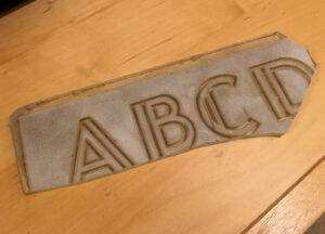 Delano Granite Works broken glass Modern alphabet.